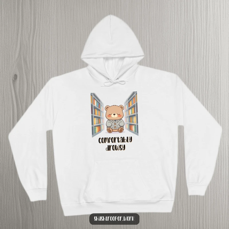 Funny bear wearing a cardigan, sleeping amongst library books, featured on a warm and cozy hoodie.